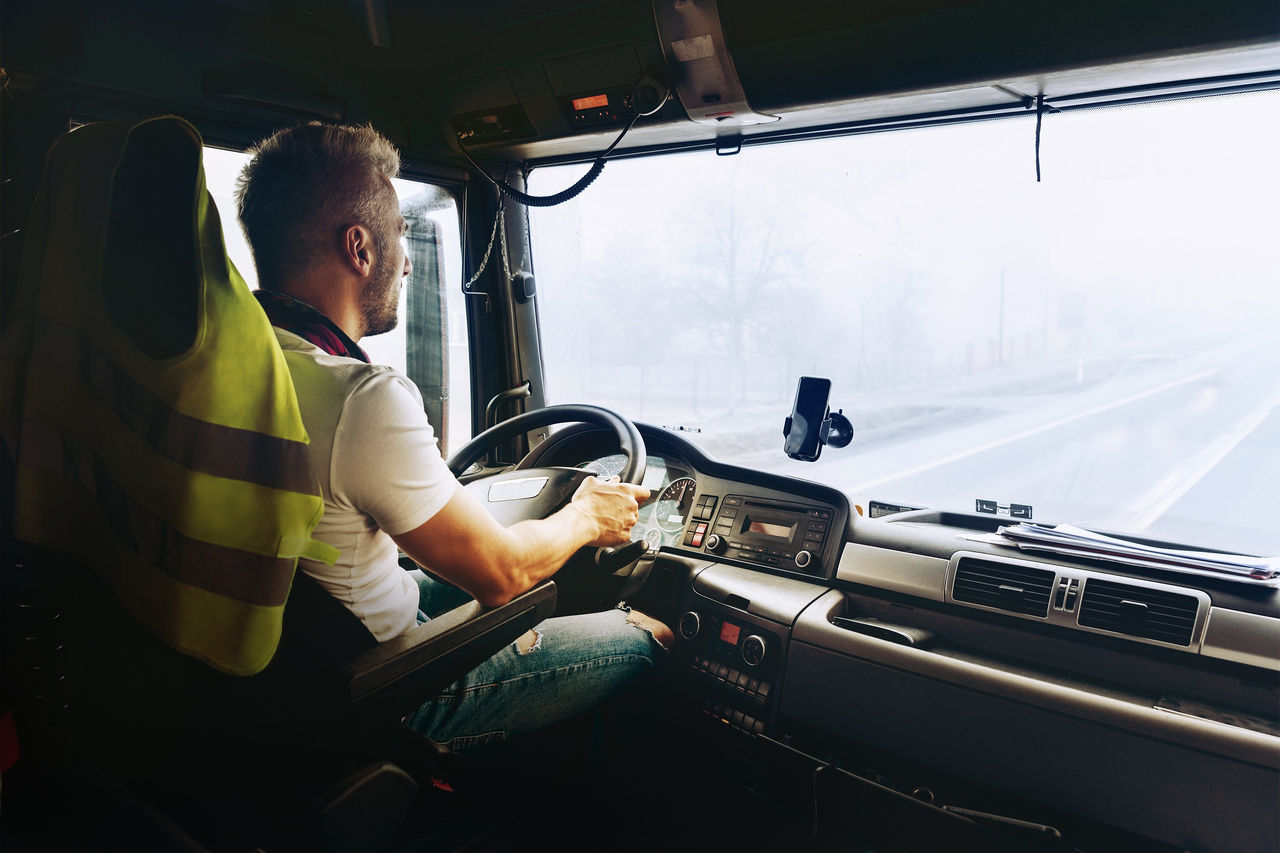 Man driving in a truck with water heater