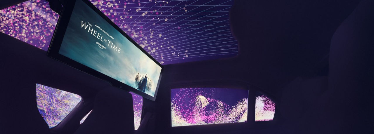 Concept car interior showcasing panoramic roof by Webasto system partner with integrated ambient LED lighting and roof display for vehicle-evolutions page.