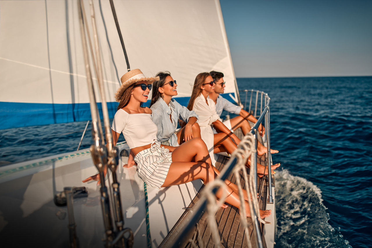 Four people aboard a sailing yacht on open sea, illustrating Webasto as a system partner for marine climate, thermal management and electrification.